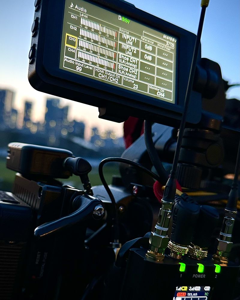 Deity receivers on a Sony FX6 at dusk, apartment towers behind