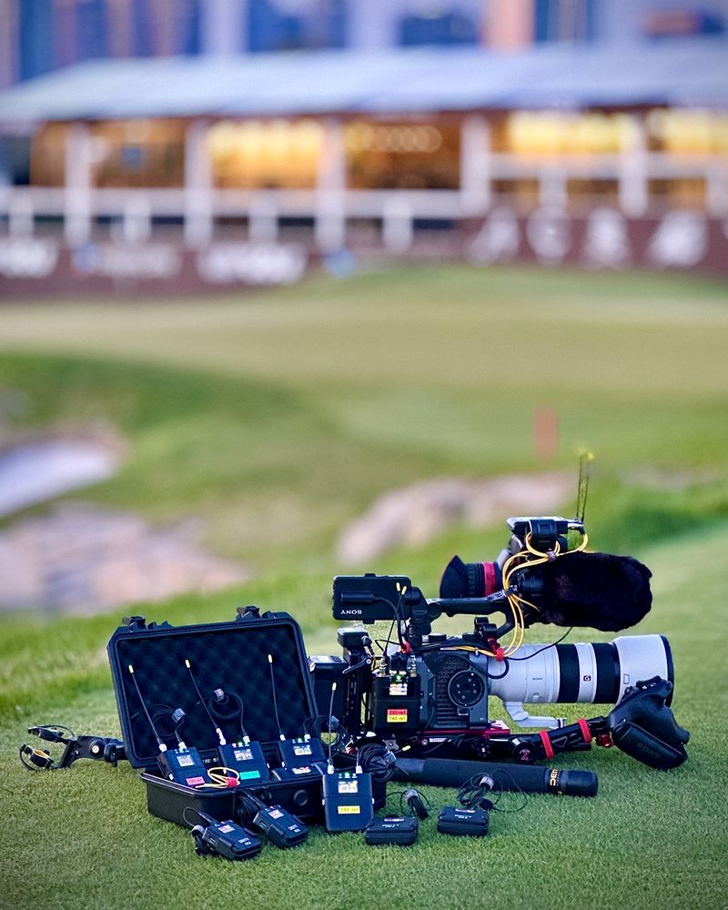 Deity Theos wireless kit and a cinema camera laid out on a golf course
