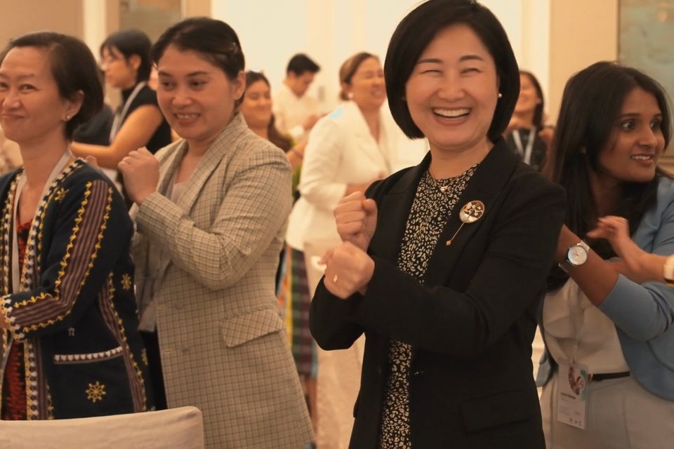Forum participants laugh during a group exercise in Manila