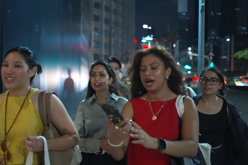 Forum participants walk through Makati at night