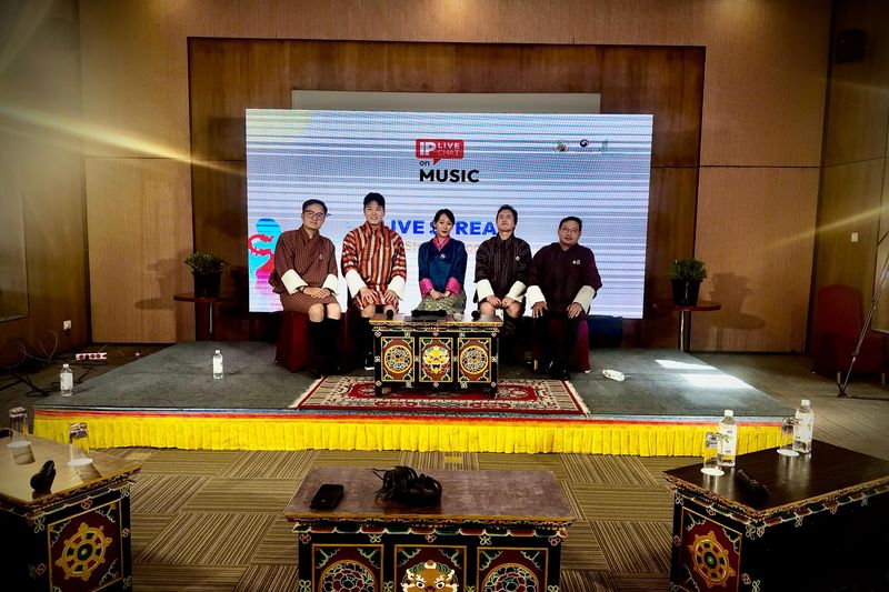 Five speakers in national dress on the IP Live Chat on music set in Bhutan