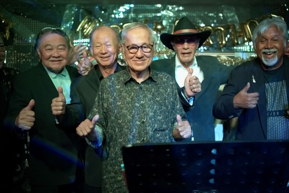 Old friends give a thumbs up together at the 80th birthday