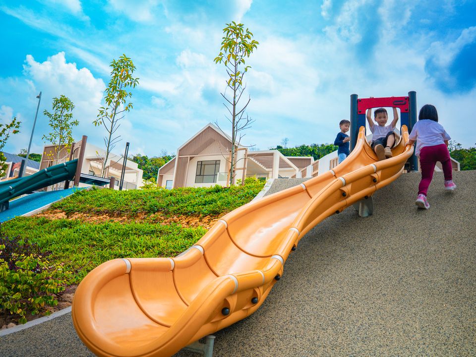 Children climb up an orange slide at Twin Palms, Kuala Lumpur