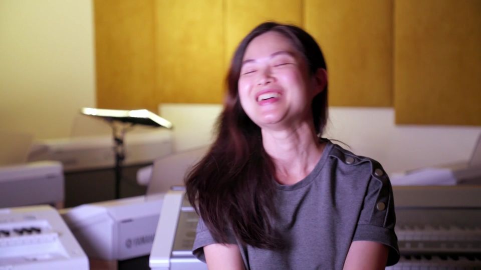A parent laughs during an interview at a Yamaha Music School in Kuala Lumpur