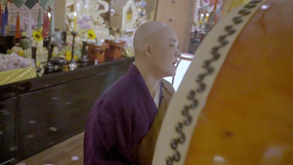A monk beside a large drum at the Cintamani Assembly