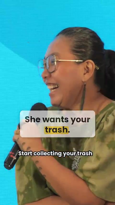 Willie Garcia speaks on stage; her caption reads She wants your trash