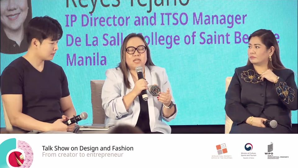 The talk show anchor and two panellists on stage in Manila