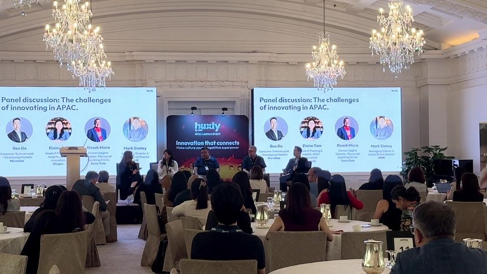 A full room listens to a panel at the Huxly APAC launch at The Fullerton Hotel